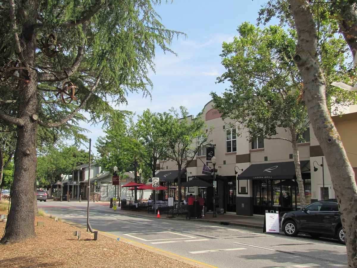 Tree-lined Monterey Road in downtown Morgan Hill, California, with sidewalk cafes and shops