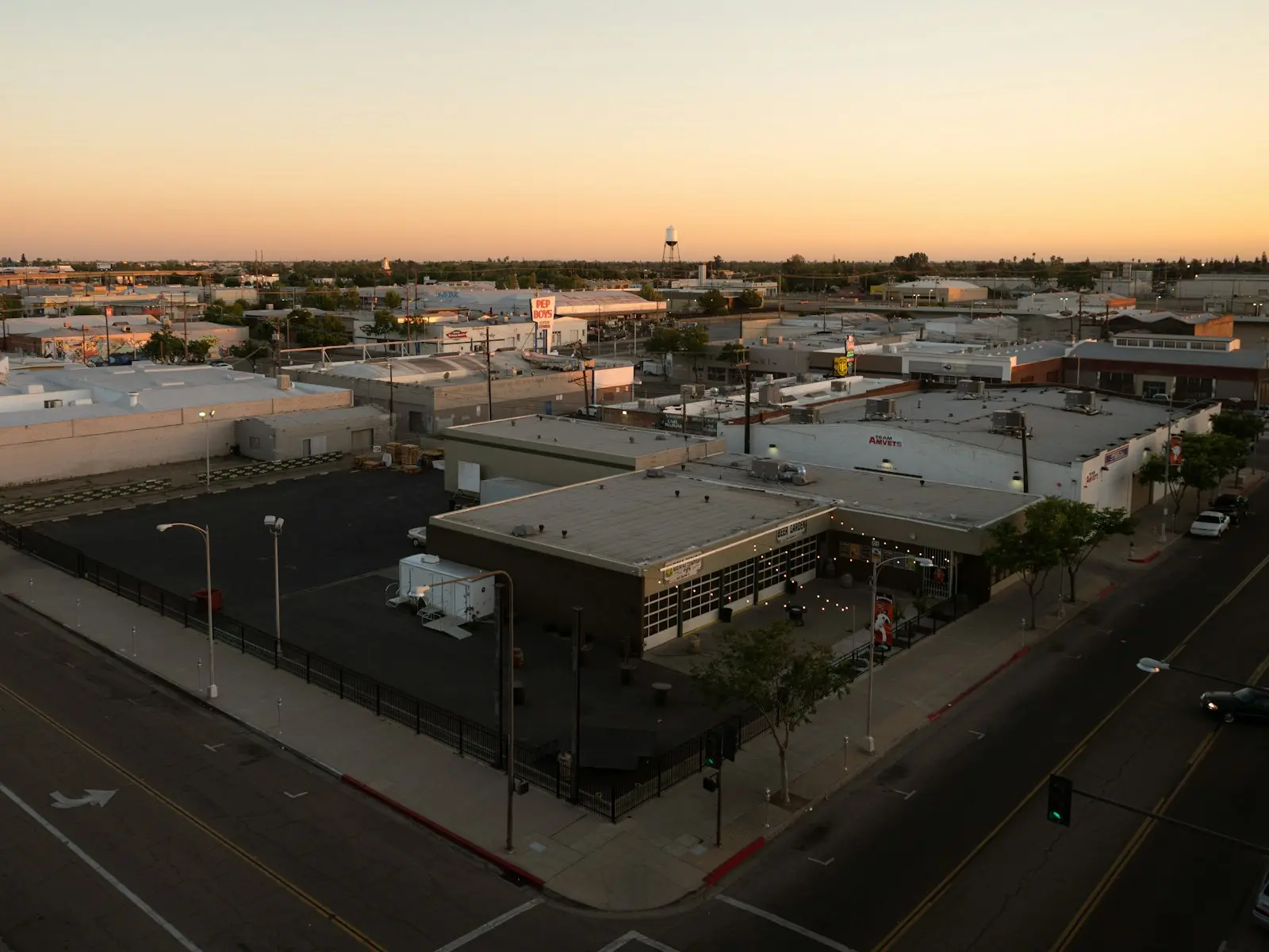 Aerial view of a Fresno street corner and rooftops at sunset